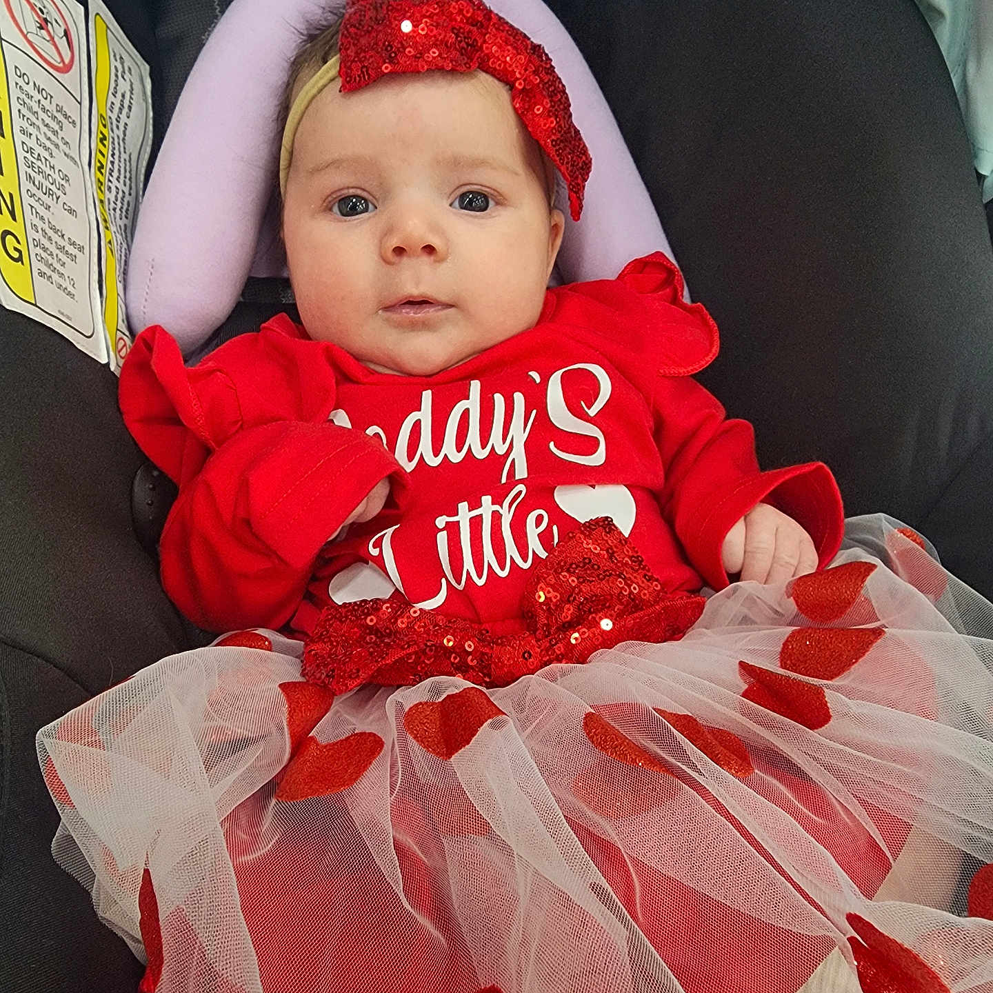Adessa is registered to the contest to win money with this photo: adorable, baby, bow, car_seat, child, cute, face, fashion, headband, hearts, holiday, indoors, infant, person, portrait, red_clothing, seated, soft_lighting, tulle_skirt, young