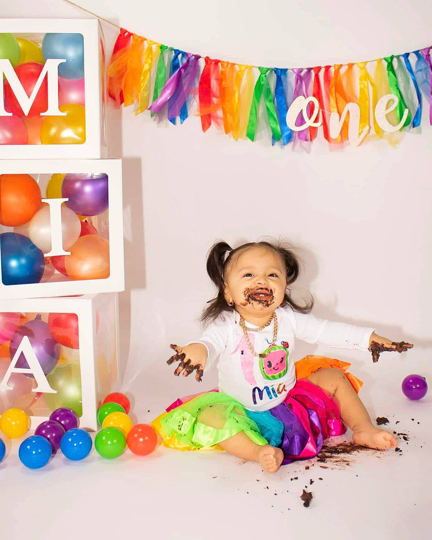 Mia is registered to the contest to win money with this photo: baby_playing_with_toys, baby_toddler_clothing, balloon, child, event, fashion_accessory, fun, happy, illustration, leisure, magenta, party, party_supply, person, play, room, smile, sweetness, toddler, toy