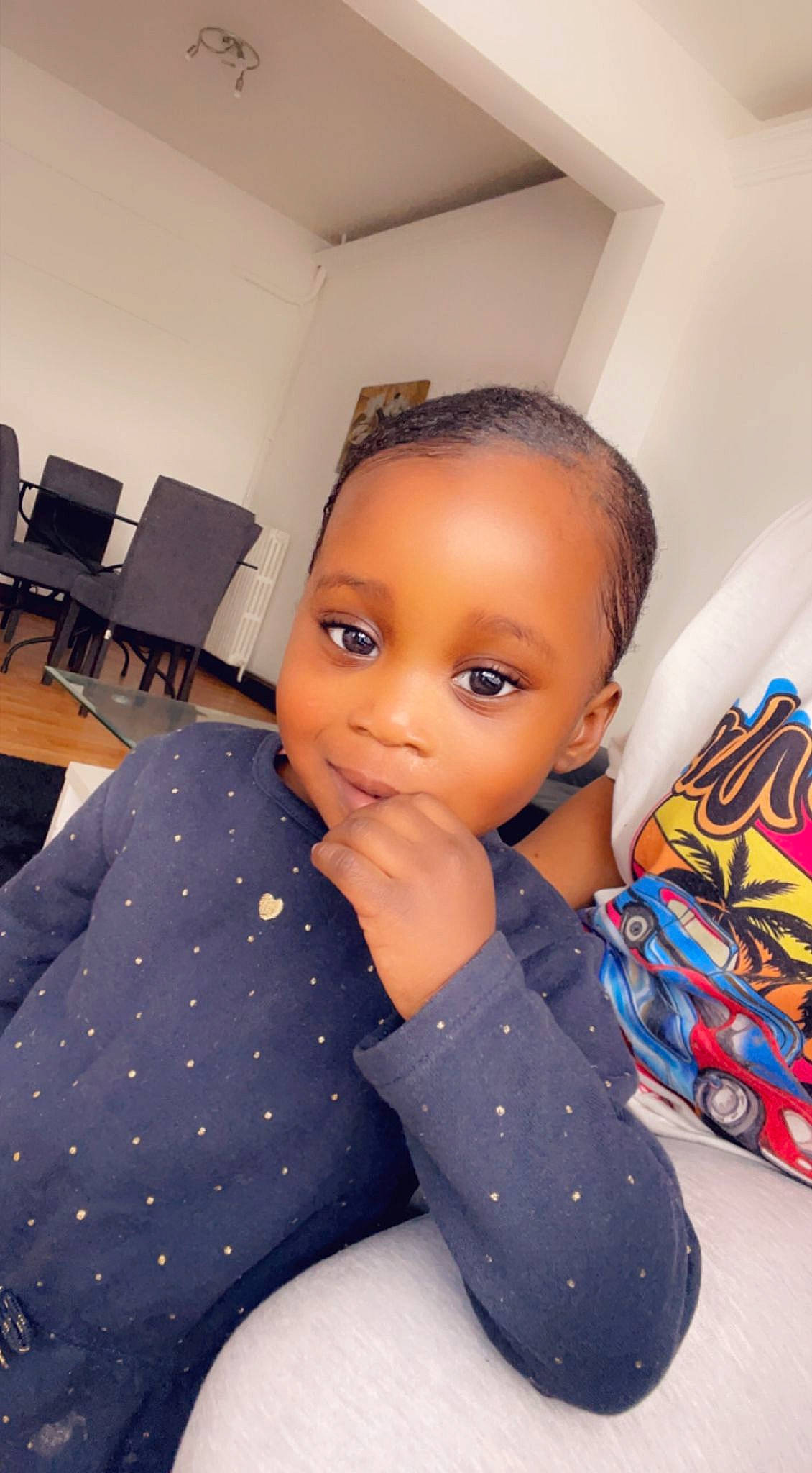 Kimberley participe au concours pour gagner de l'argent avec cette photo : black_hair, chair, chest, child, cool, electric_blue, eyelash, facial_expression, fashion_design, floor, flooring, fun, pattern, person, room, sitting, skin, thigh, toddler, toy