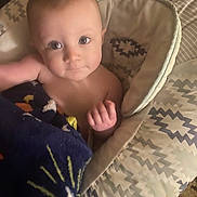 Ansleigh is registered to the contest to win money with this photo: baby, blanket, face, infant, child, seat, patterned, cozy, indoors, looking_up, cute, skin, hand, expression, comfort, young, soft, toddler, portrait, resting