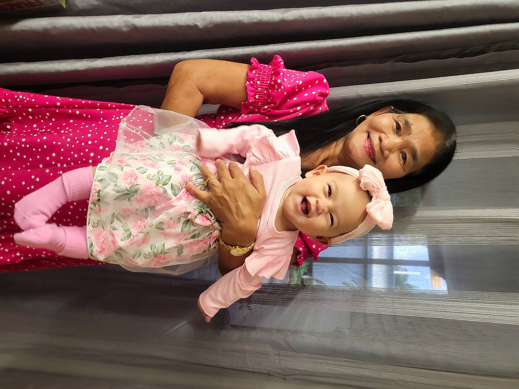 Emilie Rose is registered to the contest to win money with this photo: baby, baby_toddler_clothing, cheek, child, event, flooring, fun, happy, human_leg, joy, leisure, magenta, pattern, person, pink, portrait_photography, red, sitting, skin, smile