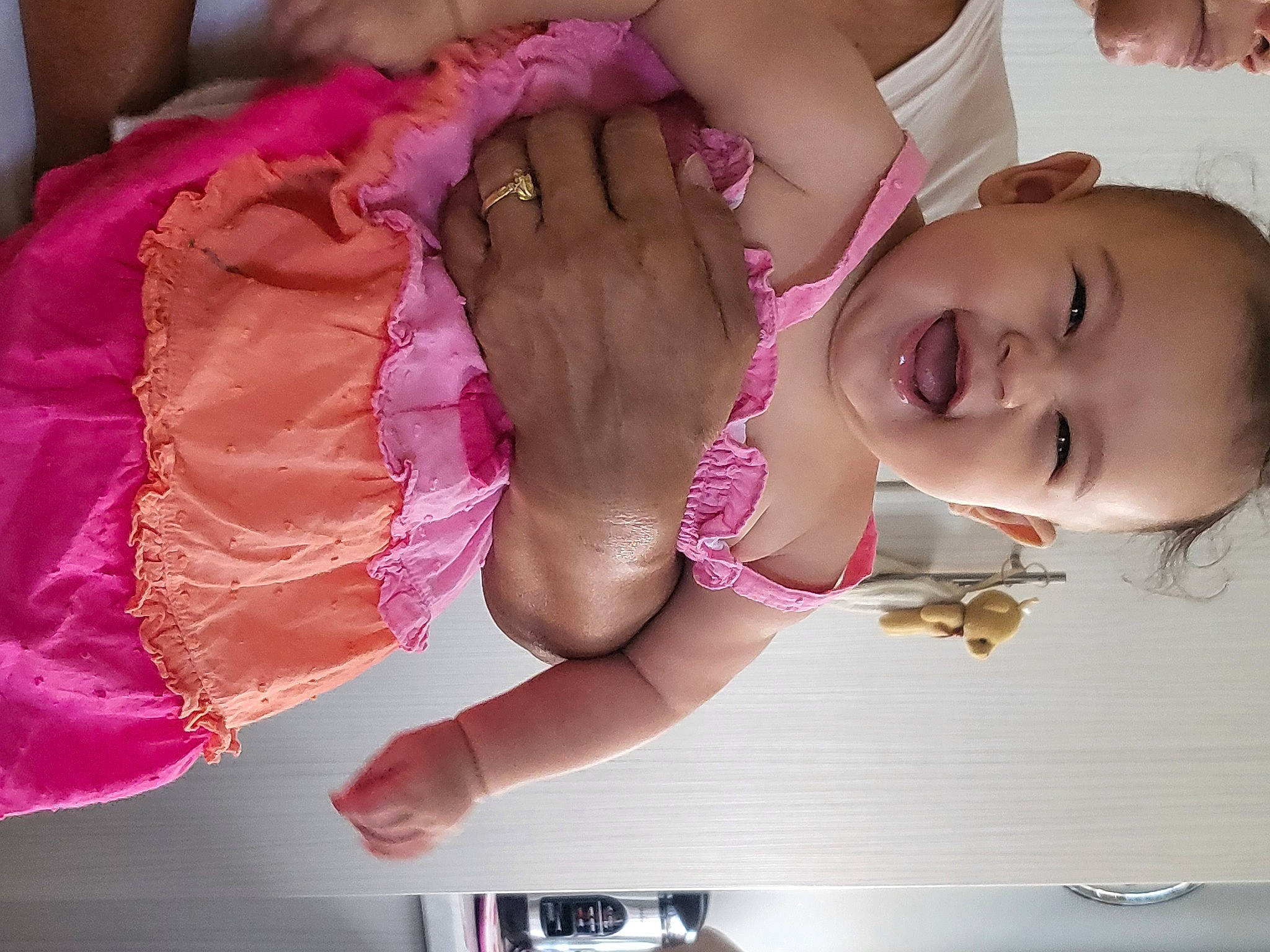 Emilie Rose is registered to the contest to win money with this photo: arm, baby, baby_toddler_clothing, cheek, chest, comfort, finger, gesture, hand, happy, human_body, leg, mouth, nail, person, pink, skin, smile, thigh, toddler