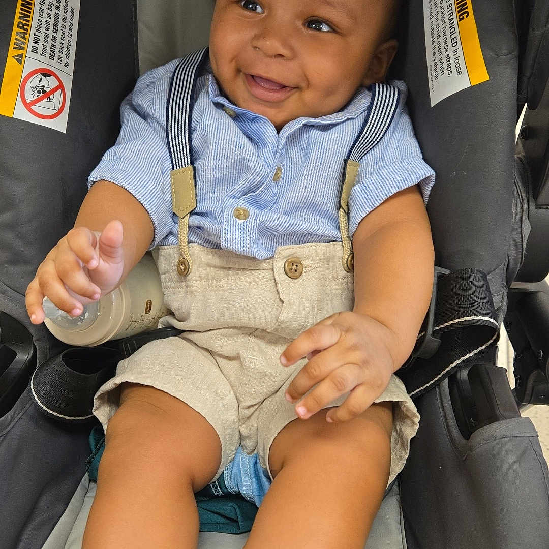 Ezequiel joined the competition — help win amazing prizes! accessories, baby, bodypart, clothing, coat, cushion, face, finger, furniture, hand, happy, head, homedecor, jacket, pants, person, photography, portrait, shorts, smile