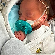 Nyla joined the competition — help win amazing prizes! newborn, baby, infant, sleeping, pacifier, swaddle, blanket, hospital, medical_tube, nasal_cannula, oxygen_tube, hand, face, closed_eyes, hospital_gown, incubator, cozy, resting, tiny_hand, crib