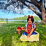 child, girl, smiling, costume, snow_white, apple, basket, roses, grass, tree, outdoor, nature, lake, blue_sky, sunlight, dress, portrait, happy, playful, fairy_tale