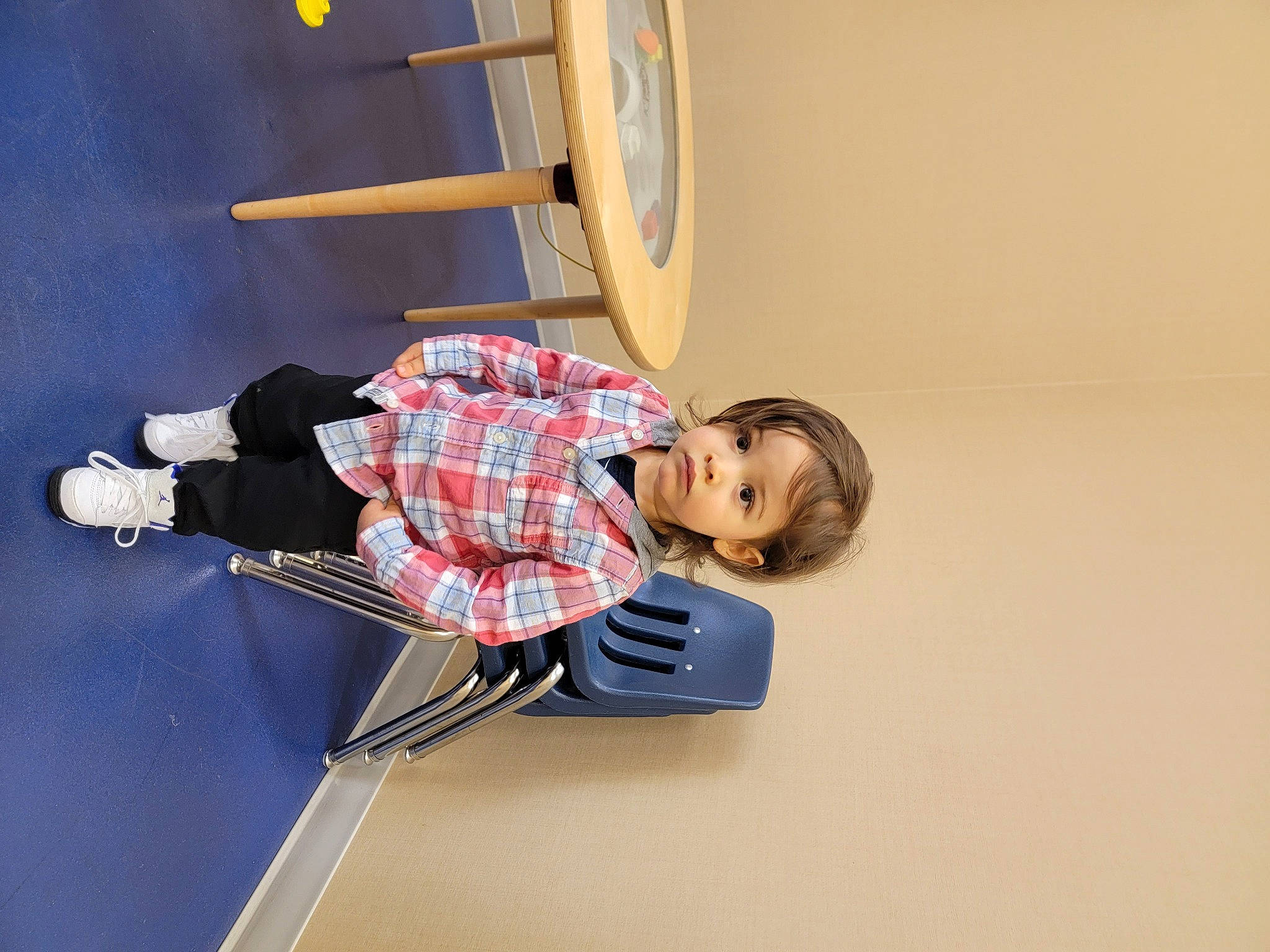 Luca is registered to the contest to win money with this photo: adventure, building, chair, child, comfort, elbow, flooring, fun, knee, outdoor_shoe, person, recreation, room, shelf, sneakers, sports_equipment, t_shirt, walking_shoe, wood