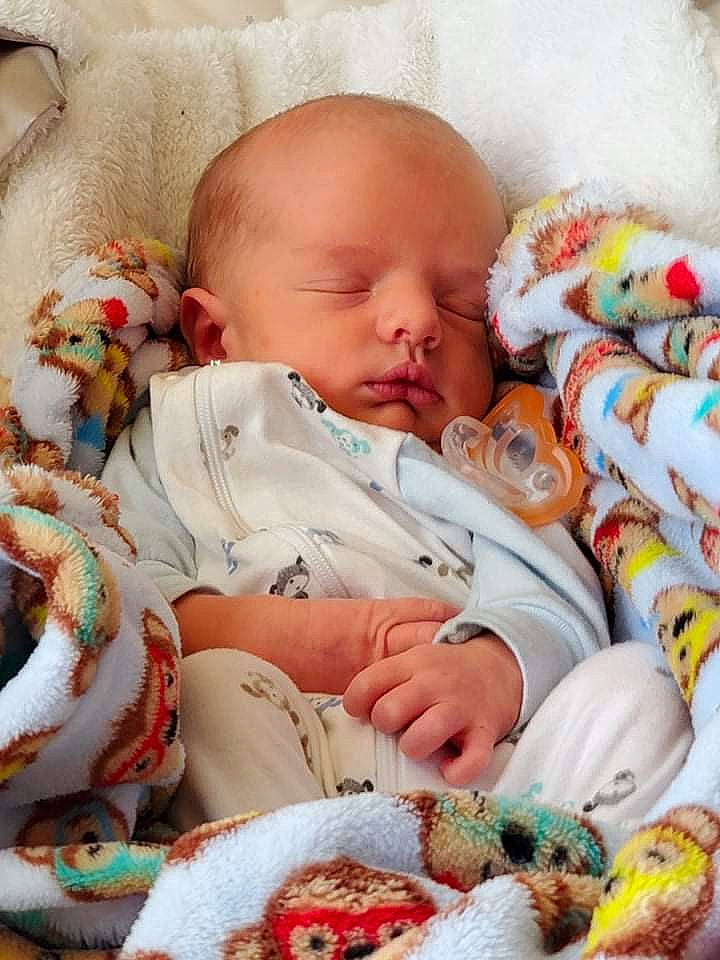 Jamie joined the competition — help win amazing prizes! baby, baby_sleeping, baby_toddler_clothing, bed_sheet, bedding, bedtime, cheek, child, comfort, linens, mammal, orange, pattern, people, person, product, room, skin, textile, toddler