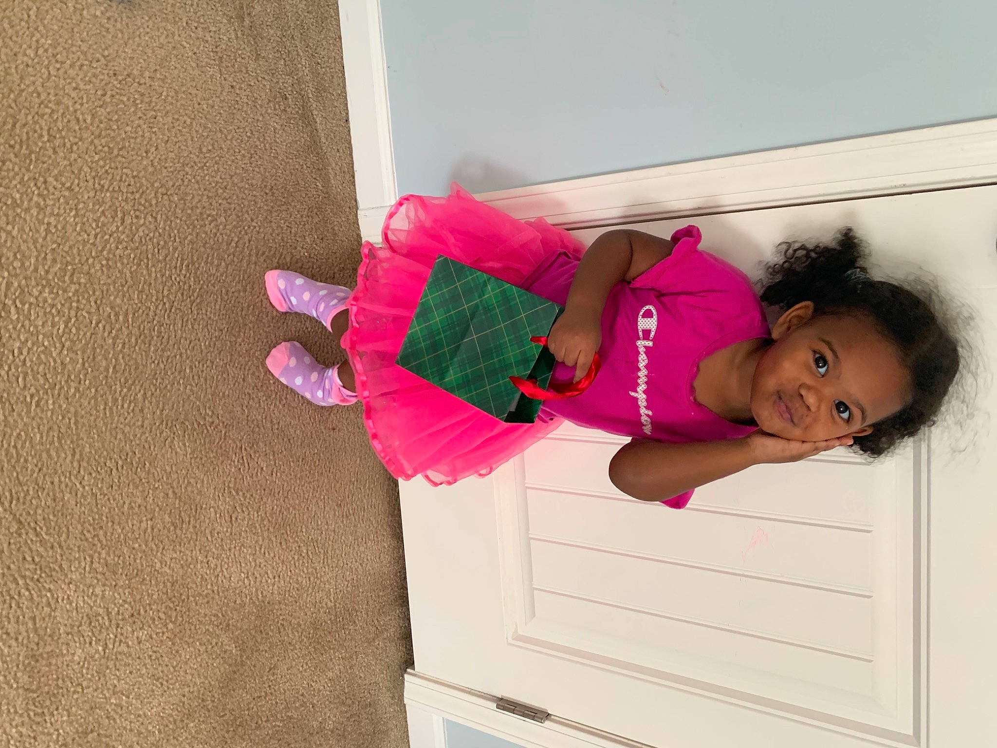 Bria is registered to the contest to win money with this photo: baby_toddler_clothing, child, comfort, dress, elbow, happy, hat, human_leg, knee, leg, magenta, person, pink, room, sleeve, sock, sportswear, t_shirt, thigh, toddler