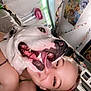 dog, person, smile, tongue_out, indoor, selfie, happy, face, closeup, pet, room, decoration, paper_chain, artwork, head, fur, collar, cheek, friendship, joy