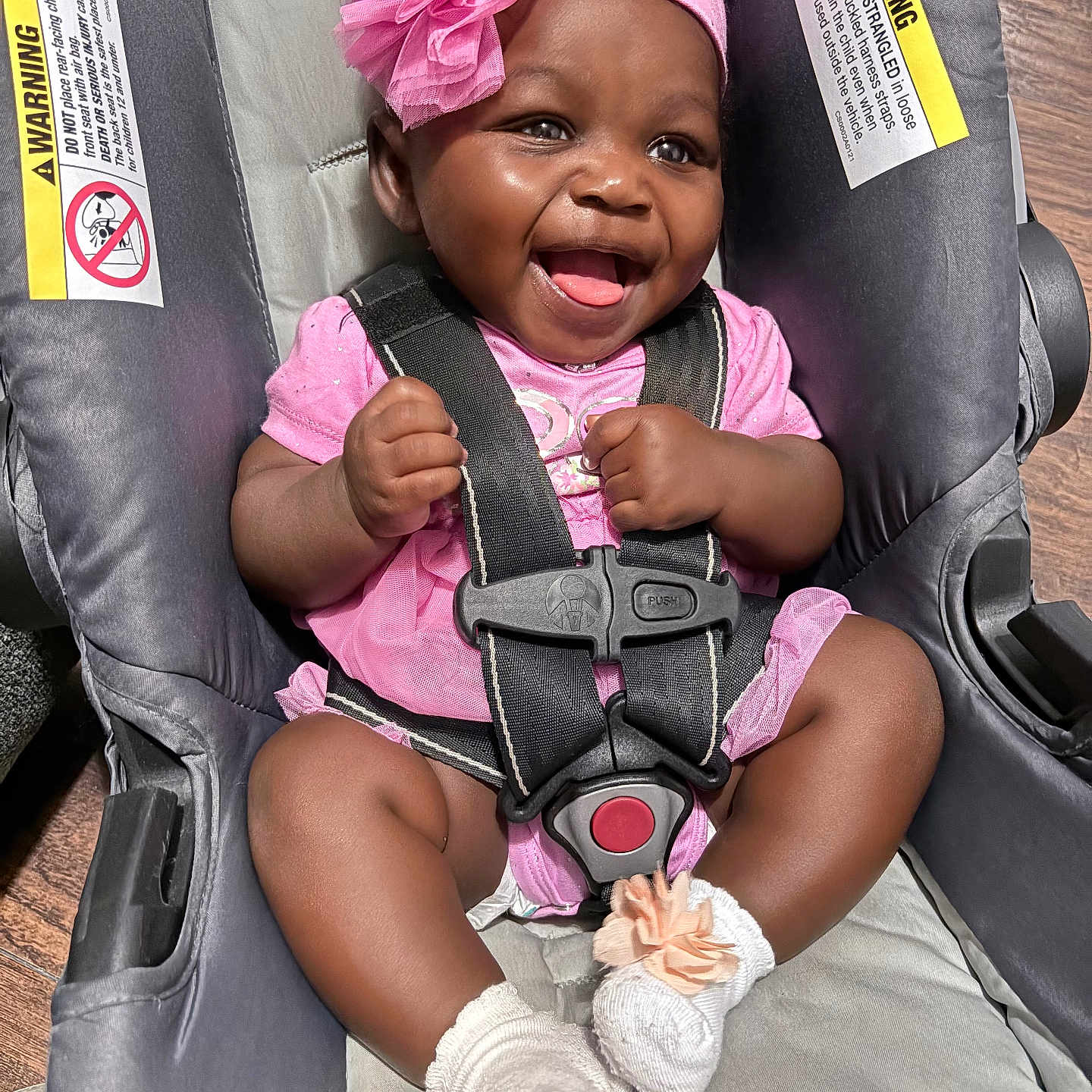 Jazmine joined the competition — help win amazing prizes! baby, car_seat, pink_clothing, headband, flower_accessory, smiling, happy, infant, socks, seat_belt, safety, child, cute, indoor, person, strap, wood_floor, closeup, adorable, portrait