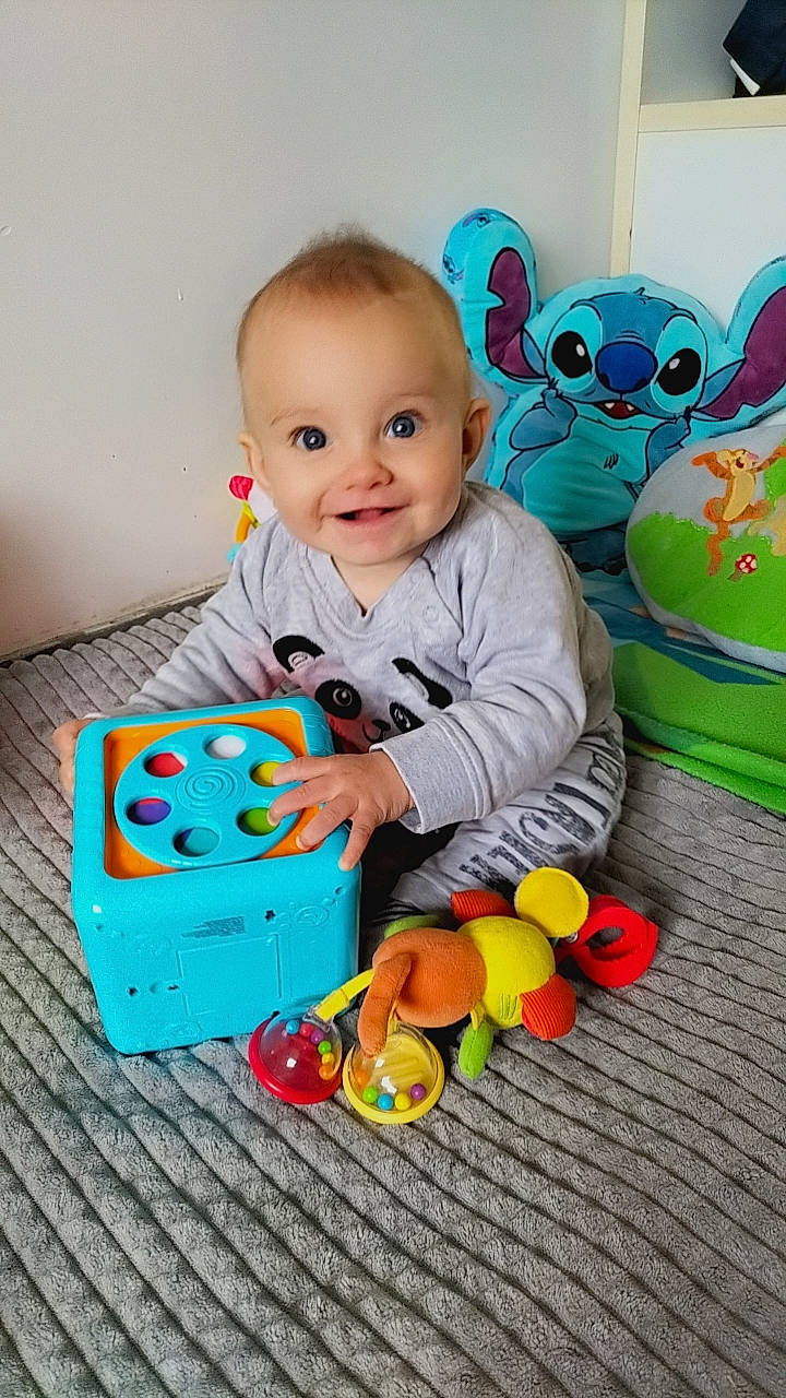 Matt participe au concours pour gagner de l'argent avec cette photo : arm, baby, baby_playing_with_toys, baby_products, baby_toddler_clothing, cheek, child, flooring, fun, green, happy, head, joy, person, product, sleeve, smile, stuffed_toy, textile, toddler