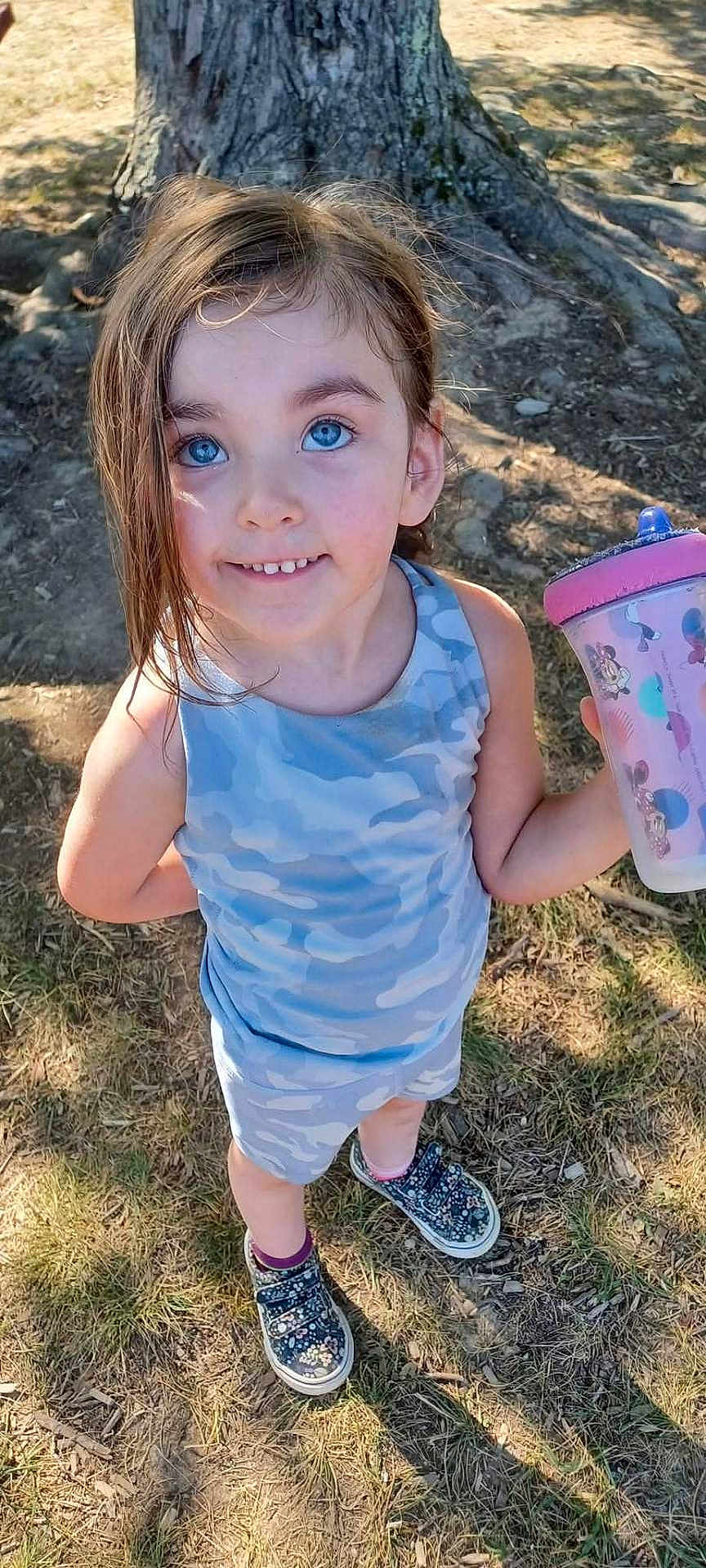 Piper joined the competition — help win amazing prizes! child, girl, blue_eyes, outdoor, tree, sunlight, sippy_cup, mickey_mouse, camouflage_clothing, shorts, sneakers, smile, standing, grass, nature, happy, person, hair, face, playful