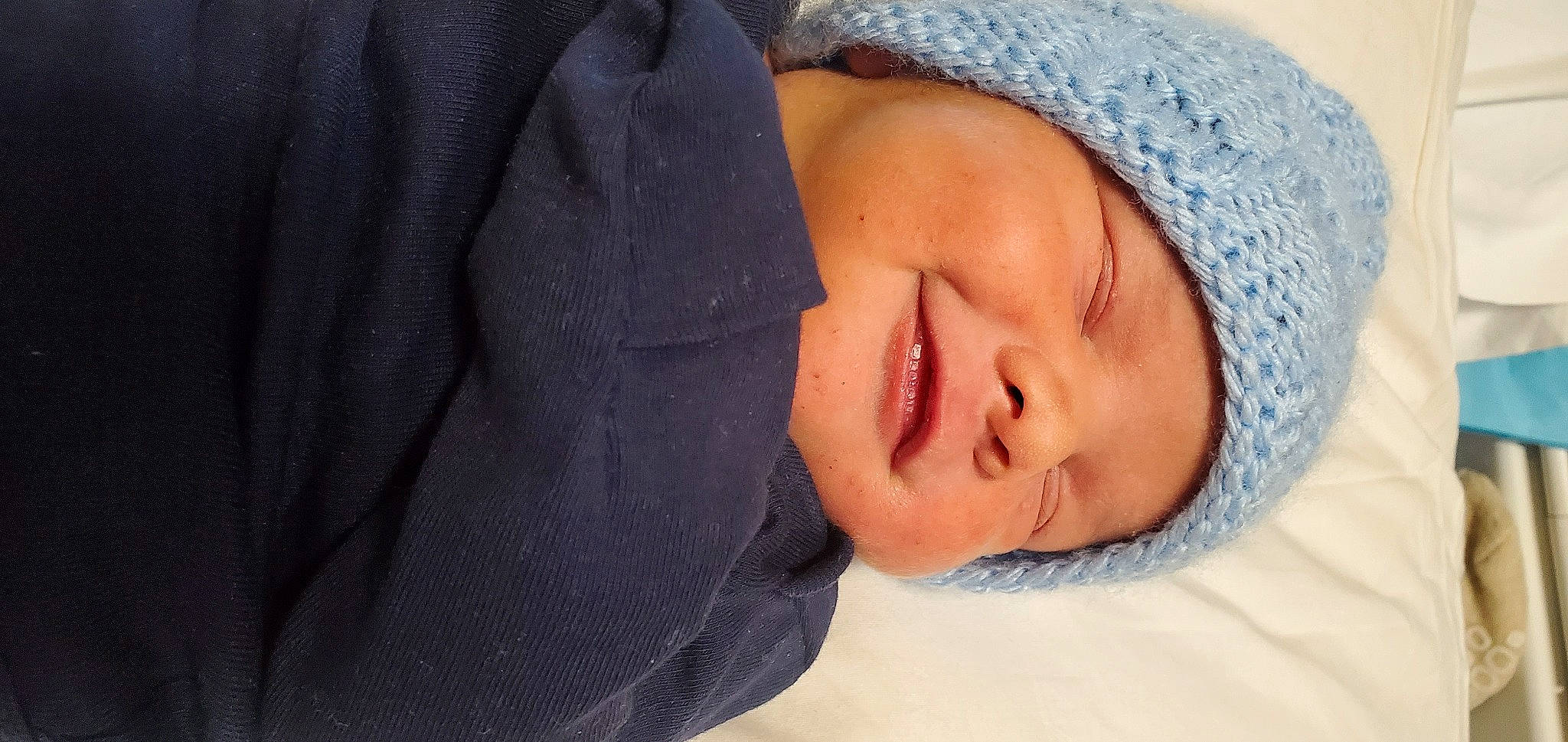 Isaiah joined the competition — help win amazing prizes! baby, baby_sleeping, baby_toddler_clothing, beanie, cap, cheek, child, comfort, electric_blue, face, fashion_accessory, happy, headwear, knit_cap, linens, lip, nose, person, portrait_photography, smile