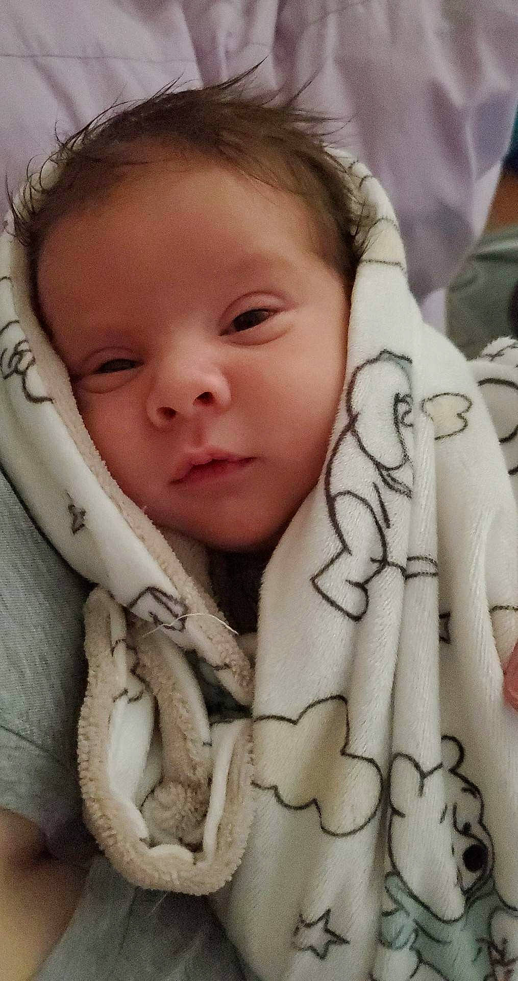 Isaiah is registered to the contest to win money with this photo: baby, beauty, cheek, comfort, eyebrow, eyelash, facial_expression, gesture, happy, human, linens, lip, mammal, mouth, nose, person, product, skin, sleeve, textile