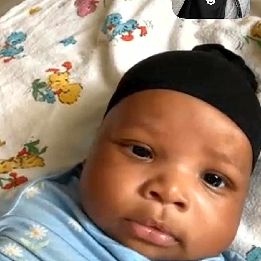 Edjen joined the competition — help win amazing prizes! adult, baby, beard, blanket, closeup, eyes, face, family_moment, hat, indoor, infant, inset, lips, mobile_screenshot, nose, patterned_blanket, portrait, smiling, swaddle, video_call
