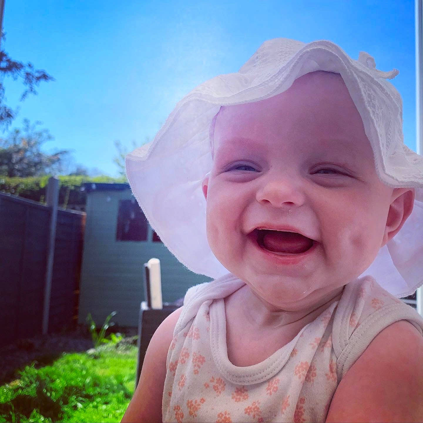 Aida-grace is registered to the contest to win money with this photo: baby, baby_laughing, baby_toddler_clothing, dress, eye, face, happy, head, house, iris, jaw, lip, neck, person, pink, plant, sky, smile, summer, toddler