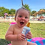 Anna participe au concours pour gagner de l'argent avec cette photo : baby, child, toddler, sunshine, outdoor, grass, sunscreen, happy, smiling, towel, hair, ponytail, summer, park, people, umbrella, relaxation, daylight, bare_chest, playful