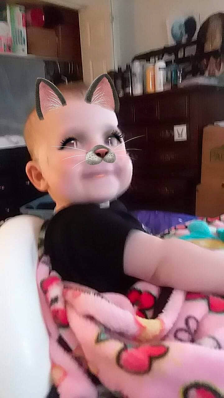 Katerina is registered to the contest to win money with this photo: cat, cheek, child, ear, eye, head, mouth, neck, person, pink, snout, textile, toy, whiskers