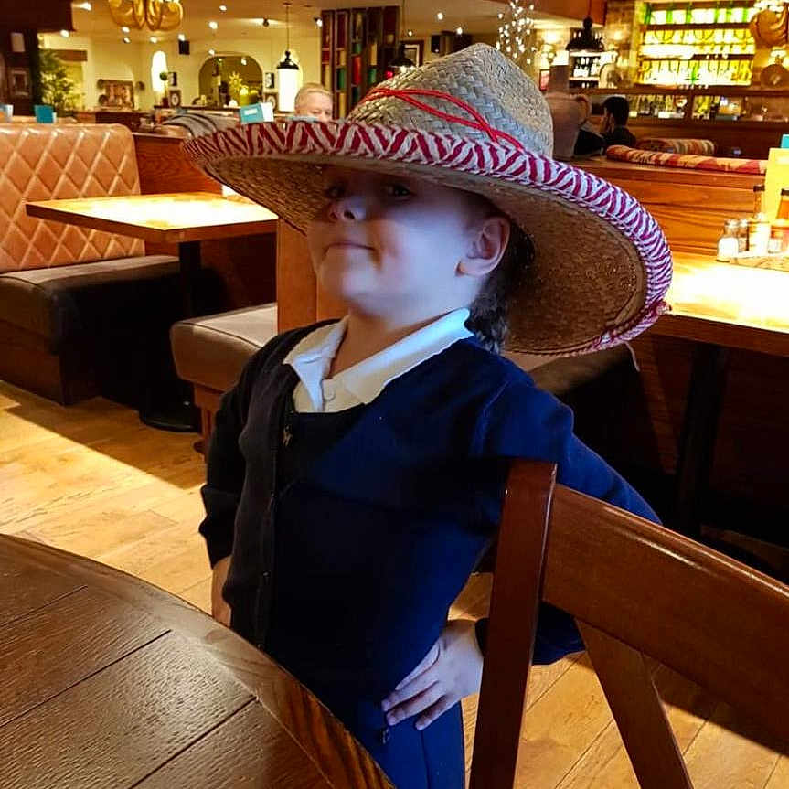 Jeru joined the competition — help win amazing prizes! background_people, casual_clothing, ceiling_lamp, child, confident, cozy, decor, flooring, furniture, hat, indoor, lighting, person, pose, restaurant, smile, sombrero, table, wooden_chair, wooden_table