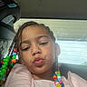 Akari joined the competition — help win amazing prizes! beads, braids, car, casual, child, colorful, cute, girl, hair, interior, natural_light, person, pink_clothing, portrait, pucker_lips, seat, selfie, smile, window, young