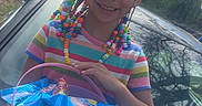 Akari joined the competition — help win amazing prizes! accessory, basket, braids, candy, car, child, colorful_beads, daylight, girl, happy, nature, outdoor, portrait, smiling, snacks, spring, striped_dress, toy, trees, yellow_bow