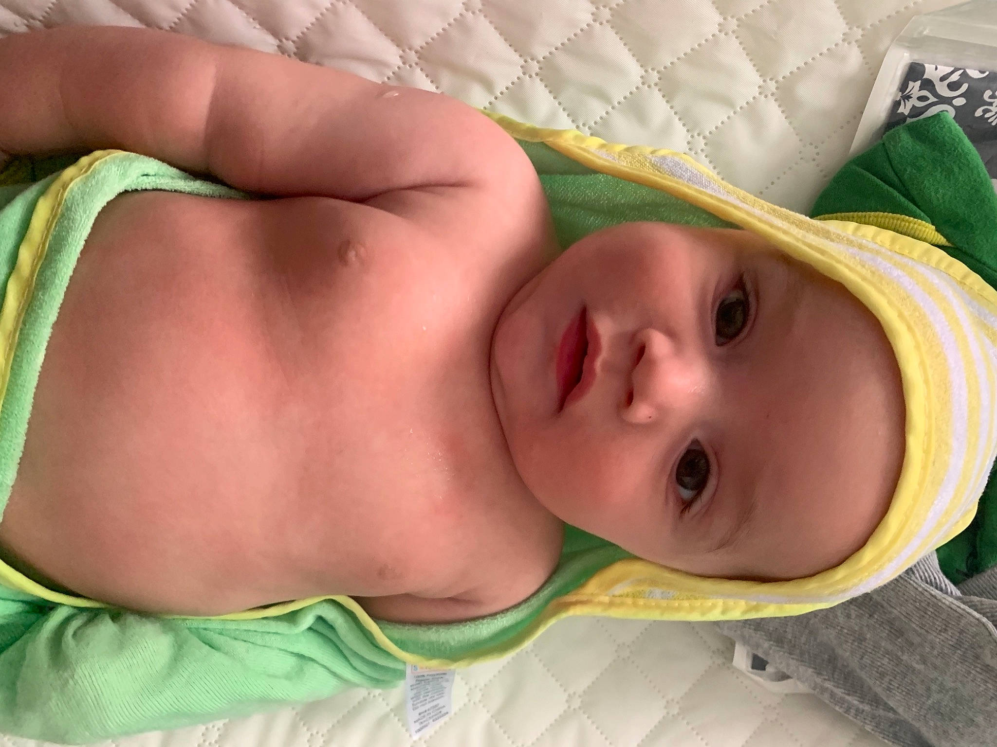 Chad is registered to the contest to win money with this photo: baby, baby_toddler_clothing, cheek, chest, comfort, eye, eyebrow, eyelash, face, grass, hat, head, headwear, human_body, linens, lip, mouth, nose, person, skin