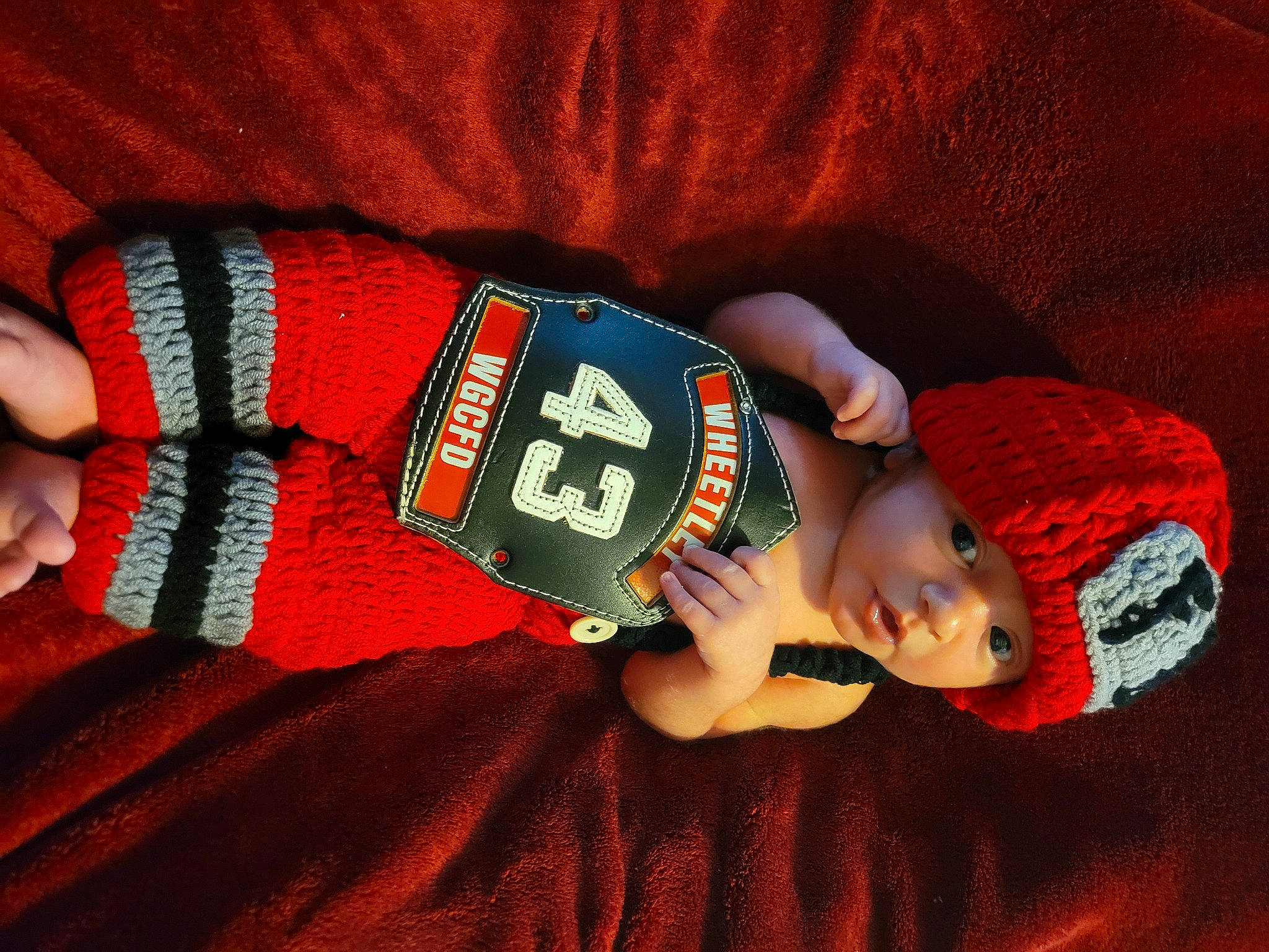 Brooks is registered to the contest to win money with this photo: baby, baby_products, baby_toddler_clothing, cap, child, comfort, eye, finger, hat, headgear, headwear, human_body, knee, linens, person, sleeve, textile, thigh, toddler, wood