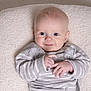 Theo joined the competition — help win amazing prizes! baby, infant, blue_eyes, smile, sweater, striped_clothing, hands, blanket, cozy, soft_texture, portrait, cute, child, indoor, baby_girl, baby_boy, face, head, skin, warm