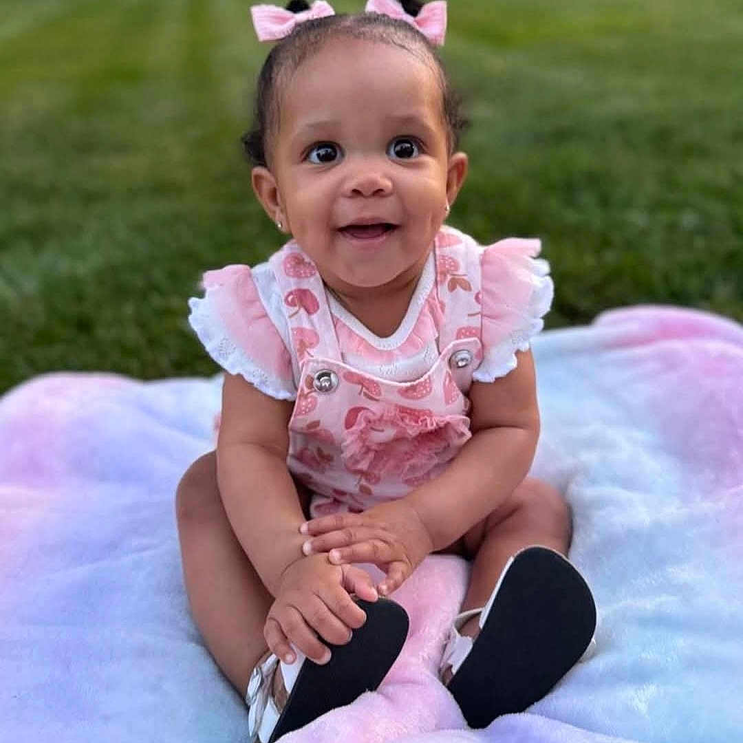 Meadow joined the competition — help win amazing prizes! baby, blanket, child, cute, dress, earrings, footwear, grass, hands, happy, infant, nature, outdoor, pink_bows, playful, portrait, short_sleeves, sitting, smiling, young_child