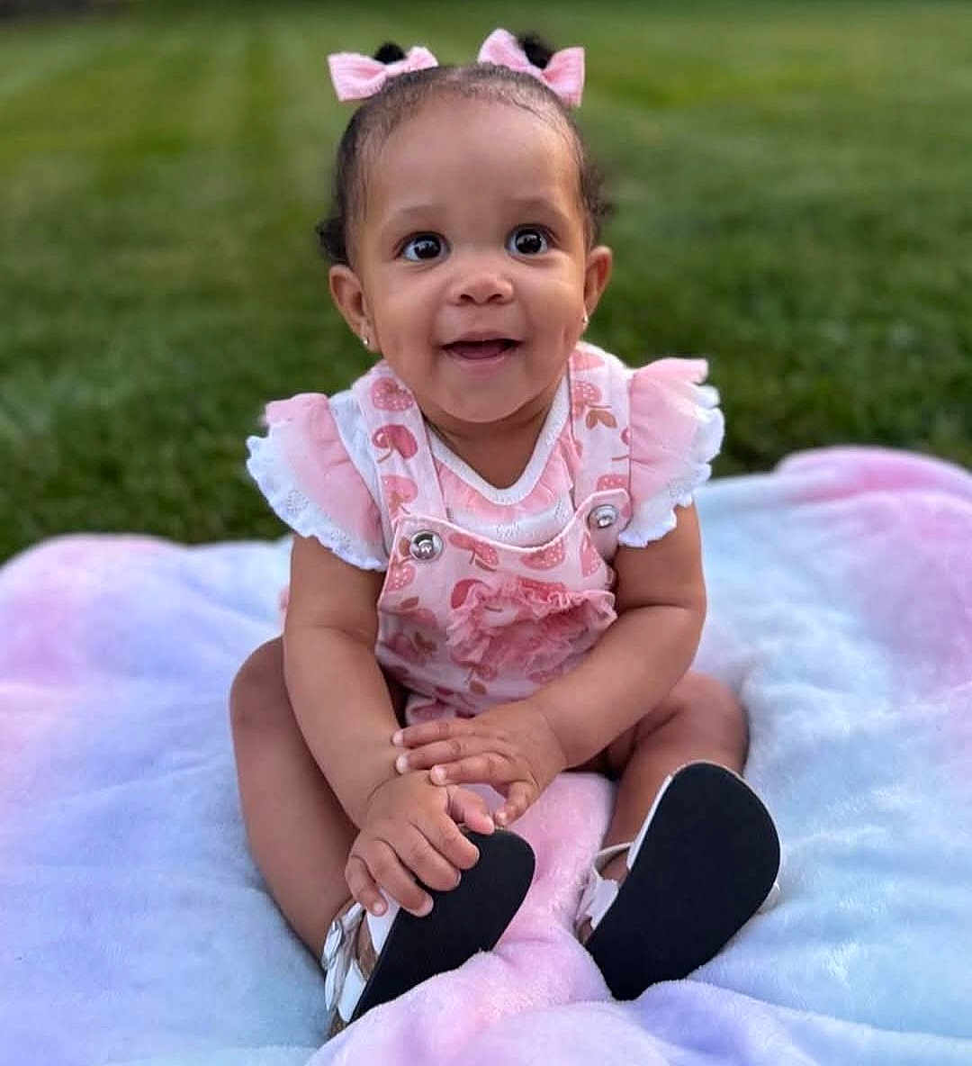 Meadow joined the competition — help win amazing prizes! baby, child, smiling, pink_bows, outdoor, grass, blanket, cute, happy, infant, sitting, footwear, dress, short_sleeves, earrings, hands, portrait, nature, young_child, playful