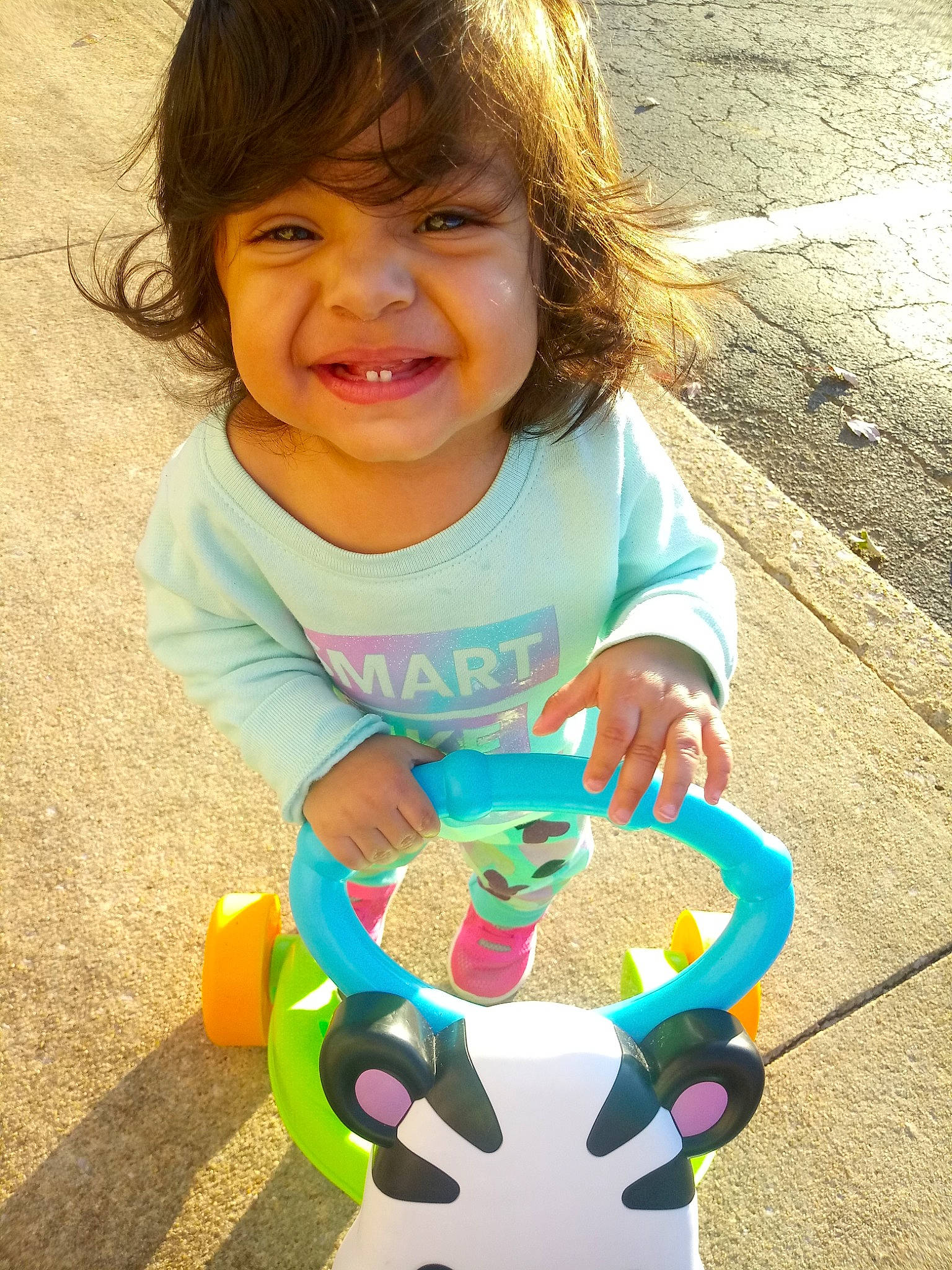 Katie is registered to the contest to win money with this photo: baby, child, fun, joy, person, play, playground, smile, toddler, toy, wheel