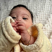 Leyden joined the competition — help win amazing prizes! baby, infant, closeup, blanket, soft_texture, hand, face, gold_bracelet, cute, wrapped, cozy, portrait, newborn, sleepwear, skin, person, lying_down, comfort, fingers, warm