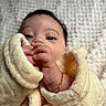 baby, infant, closeup, blanket, soft_texture, hand, face, gold_bracelet, cute, wrapped, cozy, portrait, newborn, sleepwear, skin, person, lying_down, comfort, fingers, warm