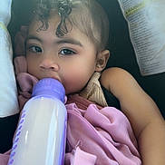 Joy joined the competition — help win amazing prizes! baby, infant, bottle, curly_hair, blanket, car_seat, child, feeding, sleepy, cute, pink, purple, clothing, hand, portrait, indoors, young_child, face, resting, comfort