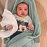 baby, bedding, blanket, bouncer, cloth, cute, face, hand, indoor, infant, laying, mickey_mouse, nursery, onesie, portrait, smile, soft_texture, towel, wide_eyes, wood_floor