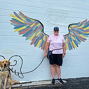 Tyrus joined the competition — help win amazing prizes! angel, cap, casual_clothing, colorful, dog, fun, golden_retriever, happy, leash, mural, outdoor, painting, person, pet, sidewalk, smile, street_art, sunglasses, wall_art, wings