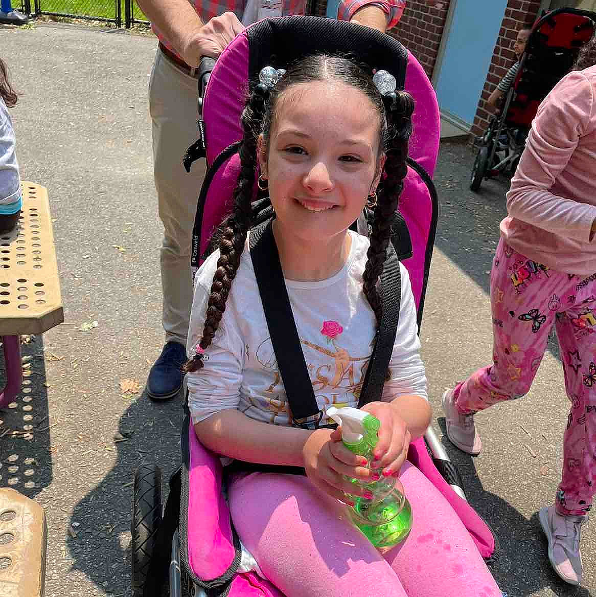 Samara is registered to the contest to win money with this photo: bag, bangs, chair, child, event, eyewear, fashion_accessory, fun, hair_coloring, hairstyle, happy, jewellery, joy, leisure, luggage_and_bags, magenta, necklace, person, pink, public_space