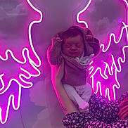 Elyanna participe au concours pour gagner de l'argent avec cette photo : baby, neon, angel_wings, pink_lighting, person, sweater, hand, tattoo, patterned_clothing, indoor, portrait, peaceful, cute, infant, face, glow, light, wall, holding, decor