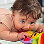 Freya is registered to the contest to win money with this photo: baby, blanket, child, closeup, colorful, cute, expression, face, fun, hand, happy, indoors, infant, person, play, skin, smile, toddler, toy, young