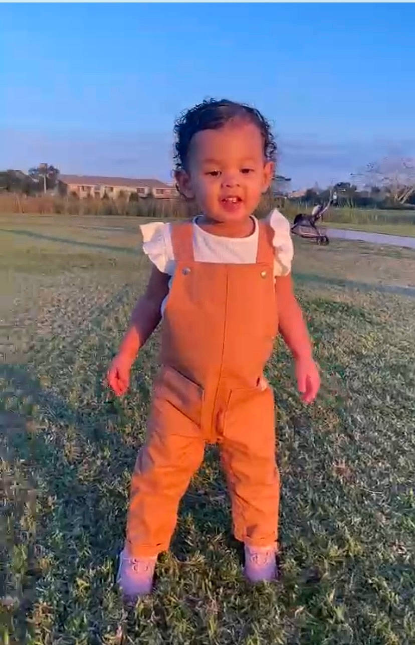 Raven joined the competition — help win amazing prizes! baby, baby_toddler_clothing, child, fun, gesture, grass, grassland, happy, landscape, people_in_nature, person, personal_protective_equipment, prairie, sky, sleeve, smile, soil, thumb, toddler, travel