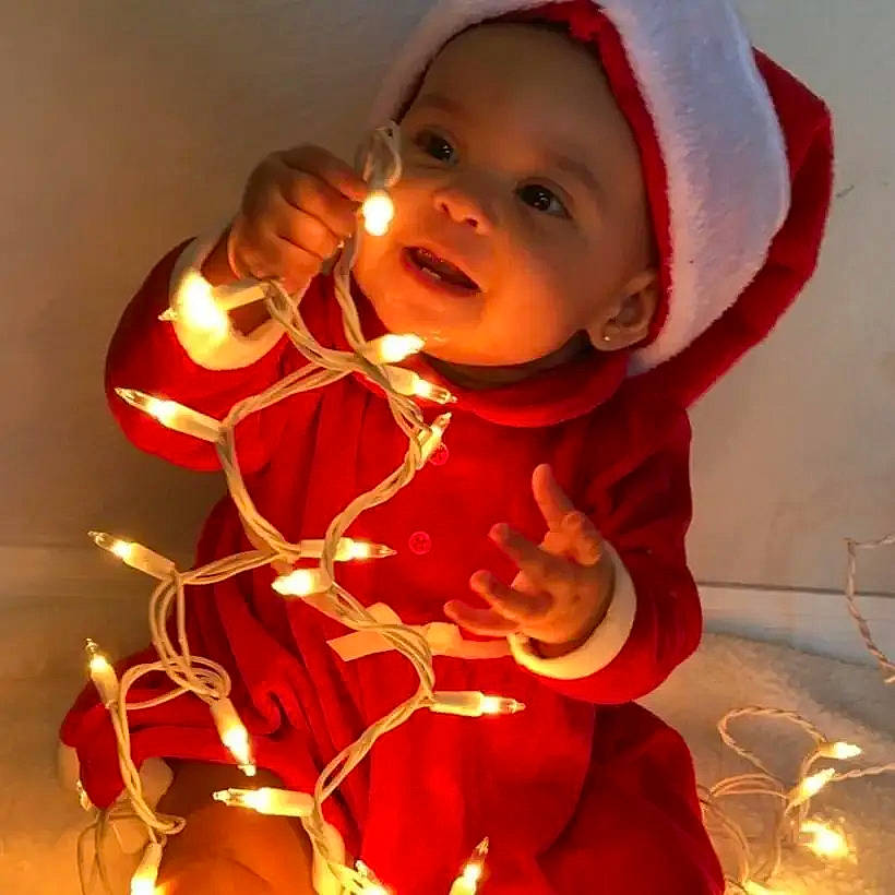 Raven is registered to the contest to win money with this photo: baby, baby_toddler_clothing, cap, carmine, child, christmas, christmas_eve, christmas_ornament, event, fashion_accessory, fictional_character, fun, happy, headwear, holiday, jewellery, lip, ornament, person, sleeve