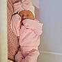 newborn, baby, sleeping, pink_clothing, hat, bow, blanket, cozy, infant, soft, cute, resting, child, wearing, pajamas, indoors, peaceful, portrait, face, headwear
