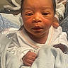 Kaiyonnie is registered to the contest to win money with this photo: baby, blanket, child, close_up, dark_hair, eyes, face, fist, hand, hospital, indoors, infant, looking_at_camera, mouth, newborn, photography, portrait, sleepy, swaddled, white_clothing