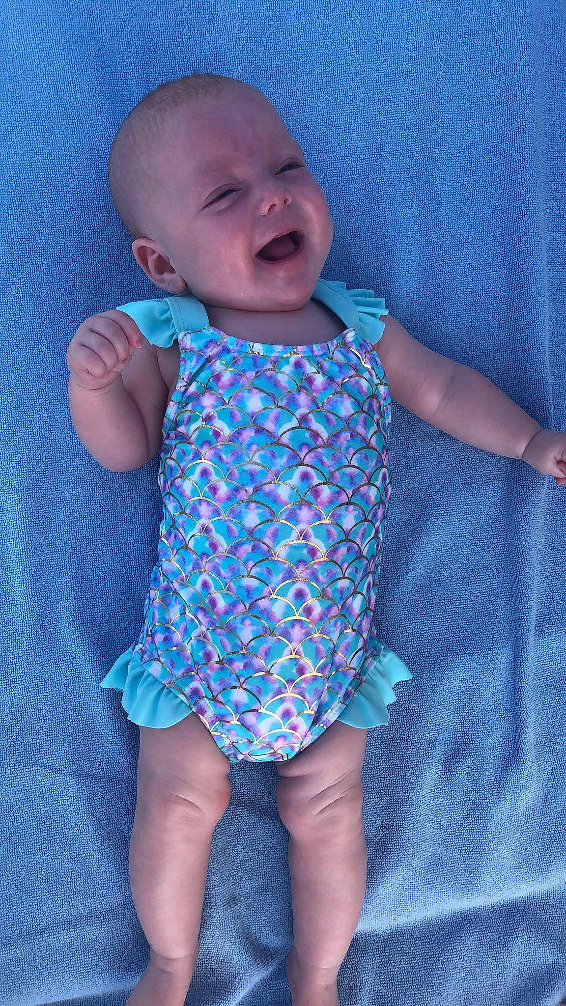 Connie is registered to the contest to win money with this photo: baby, baby_products, baby_toddler_clothing, blue, child, clothing, diaper, pattern, person, product, smile, toddler, turquoise