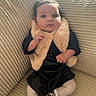baby, black_dress, child, clothing, couch, cozy, cute, expression, fashion, fur_vest, furniture, home, indoors, infant, leopard_print, person, portrait, seated, shoes, tights