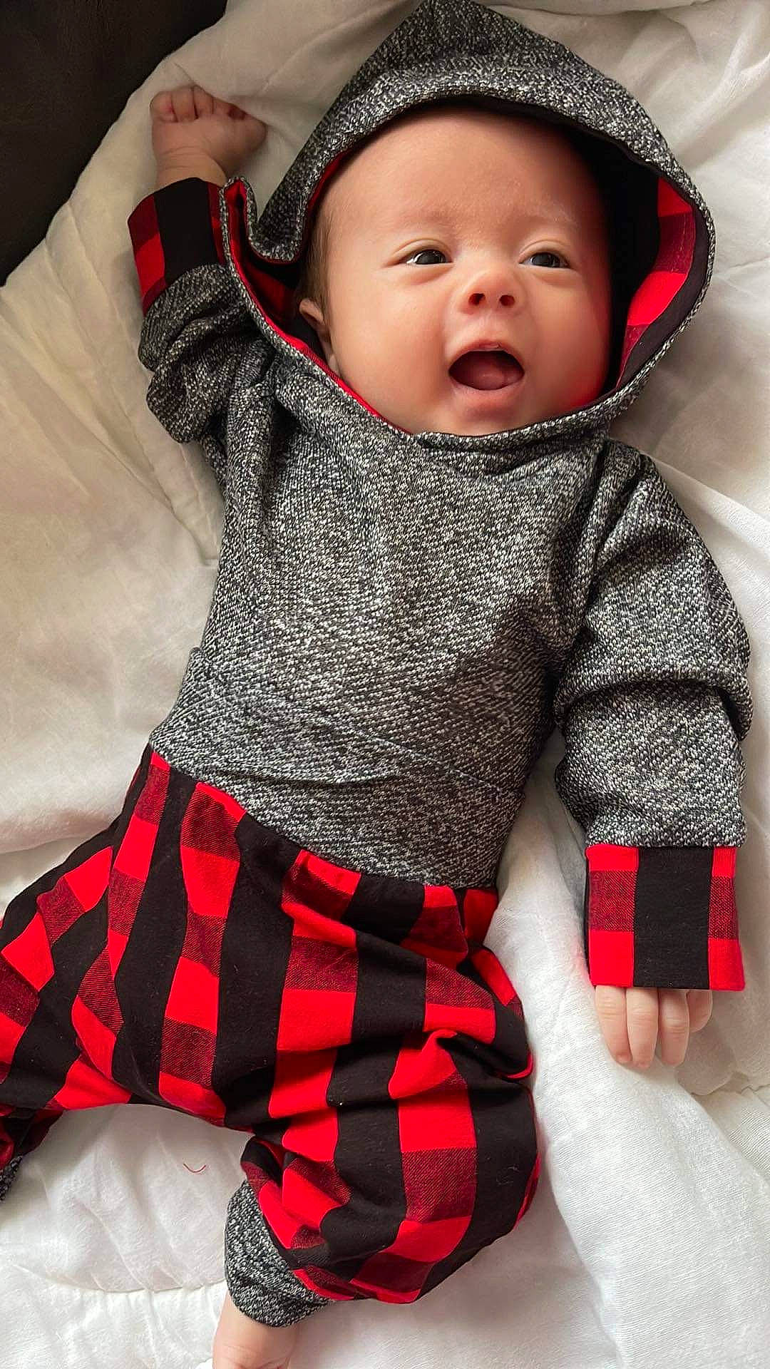 Emerson joined the competition — help win amazing prizes! baby, baby_toddler_clothing, black, cheek, child, comfort, design, finger, hand, happy, headwear, outerwear, pattern, person, plaid, red, skin, sleeve, tartan, textile