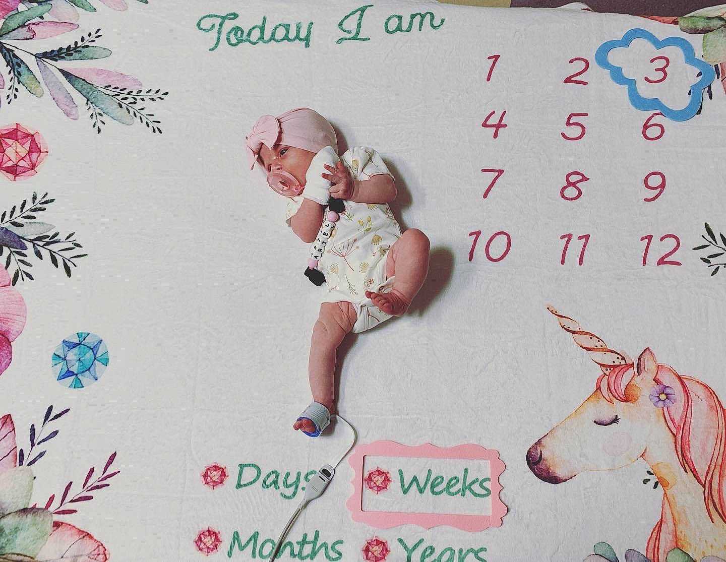 Ariel is registered to the contest to win money with this photo: art, baby_toddler_clothing, child, design, fictional_character, font, happy, illustration, livestock, pack_animal, paper, paper_product, pattern, pedicel, person, pink, tail, textile, visual_arts, white