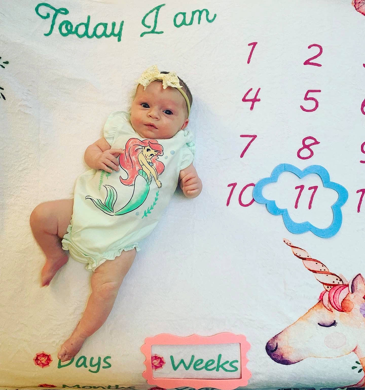 Ariel is registered to the contest to win money with this photo: baby, baby_toddler_clothing, cheek, child, facial_expression, font, foot, gesture, happy, magenta, pattern, person, pink, product, sleeve, textile, thumb