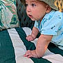 Logan joined the competition — help win amazing prizes! baby, child, crawling, hat, bucket_hat, blue_shirt, fish_pattern, cushion, striped, green, white, outdoor, curious, face, skin, hand, palm, expression, person, daylight