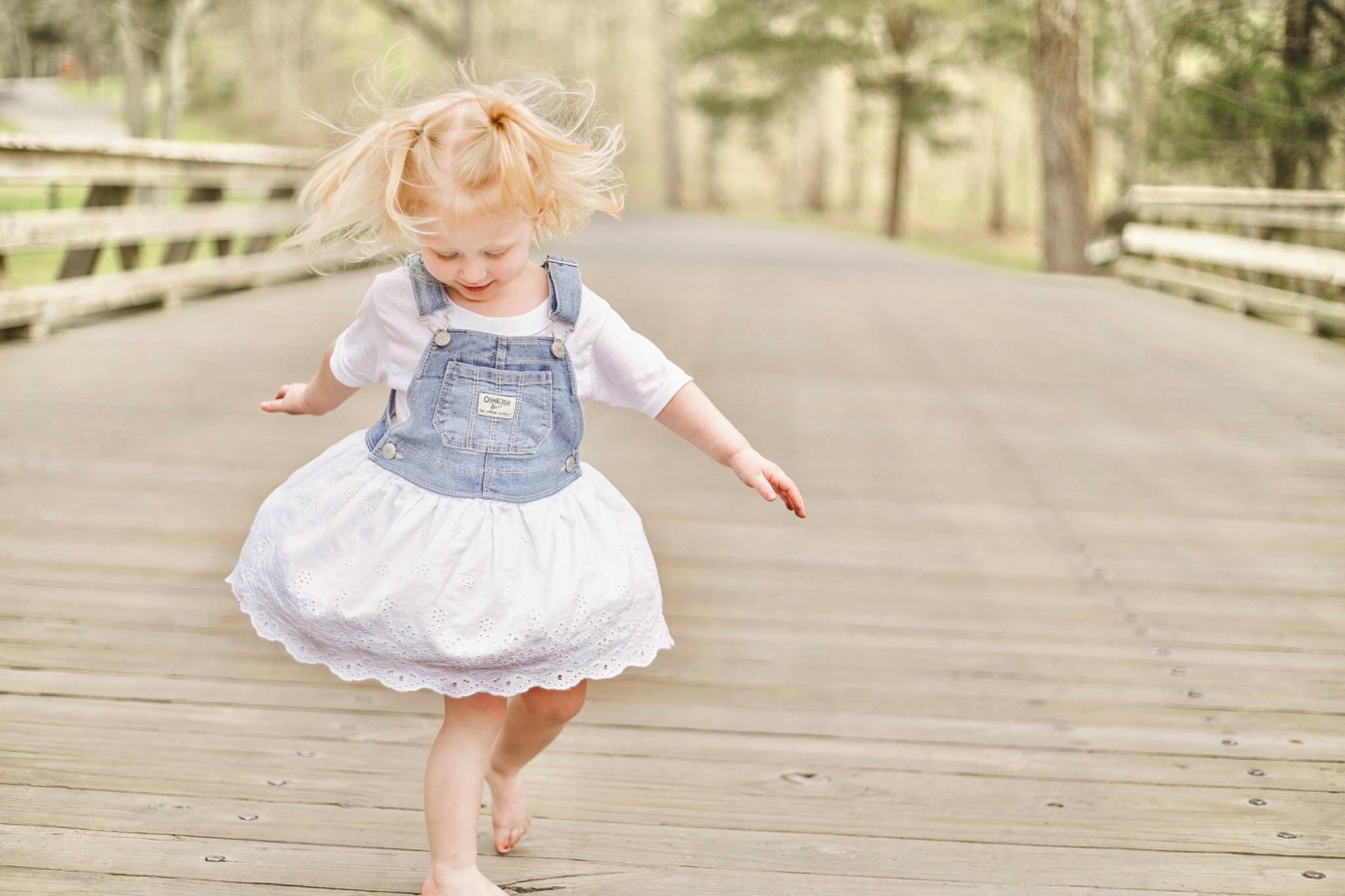 Addison is registered to the contest to win money with this photo: blond, bridal_party_dress, brown_hair, child, day_dress, dress, foot, gesture, grass, happy, leg, long_hair, pattern, people_in_nature, person, plant, smile, toddler, tree, waist
